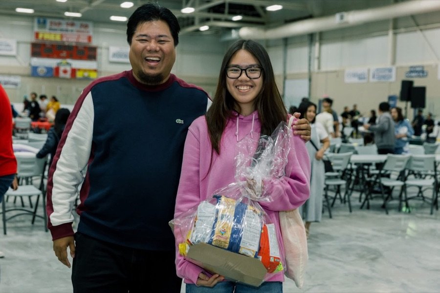 Guests posing with a prize basket
