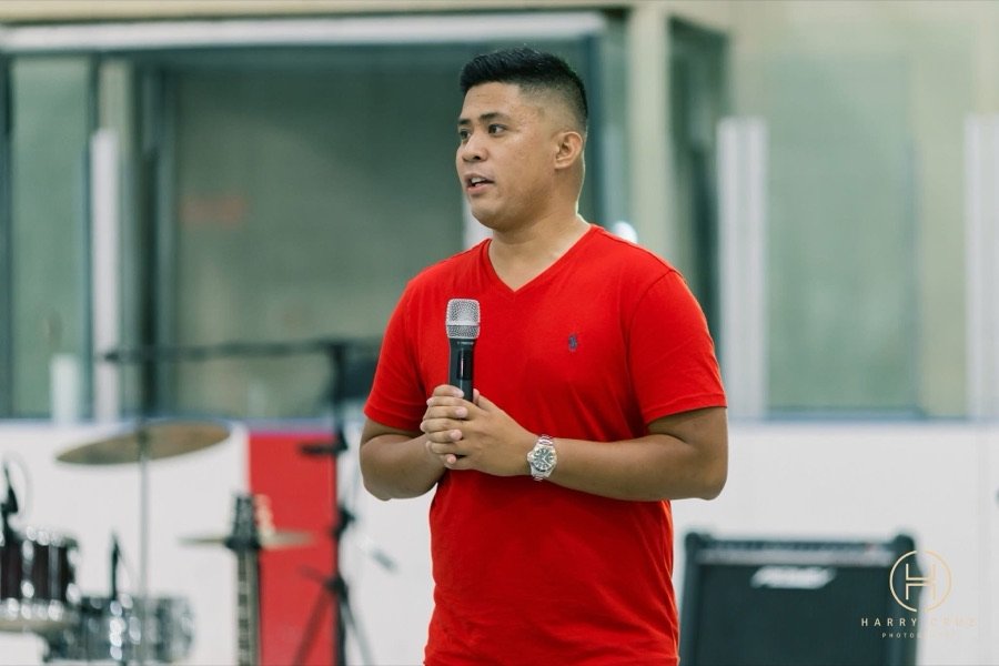 Host addressing guests with a microphone